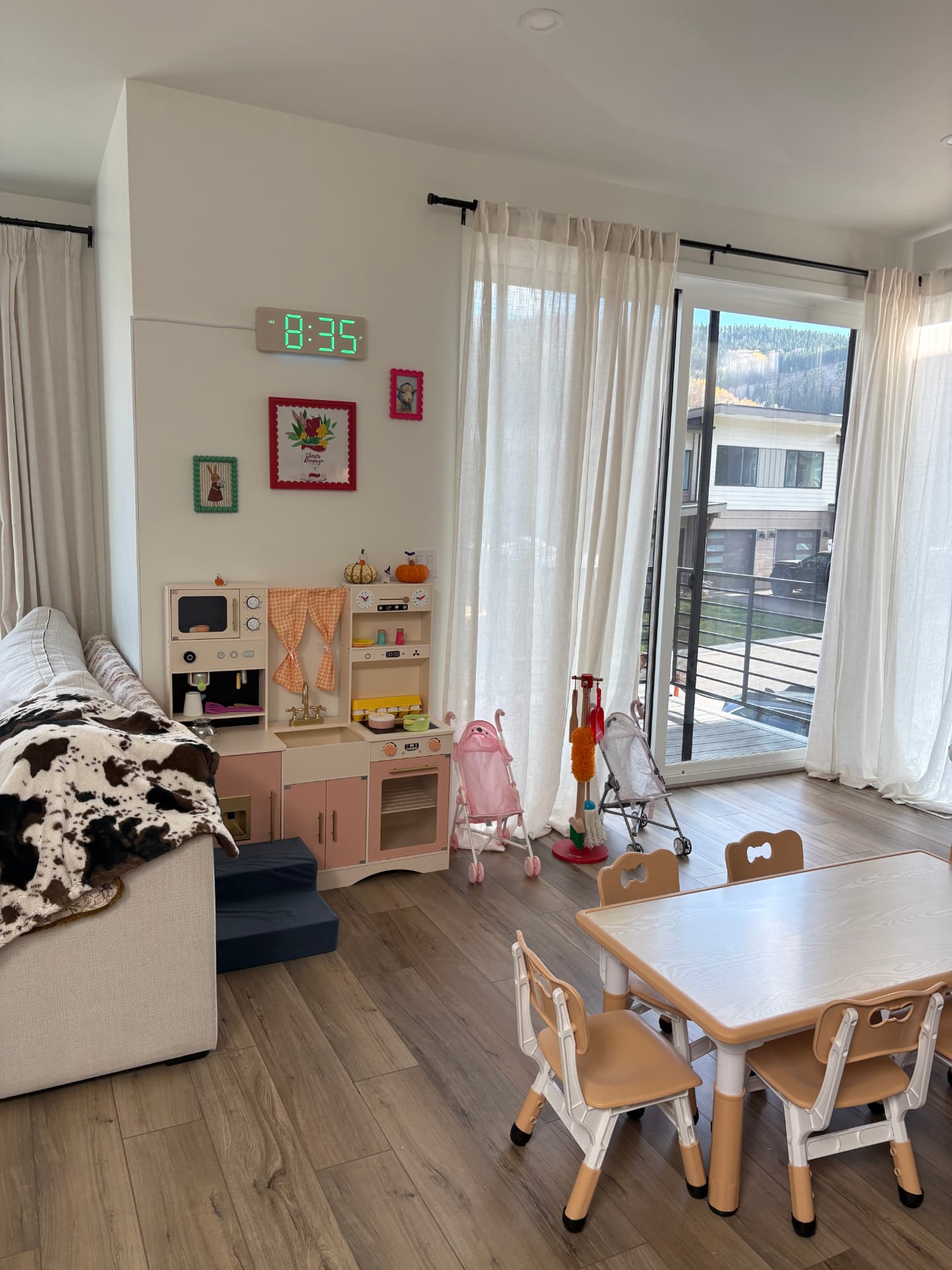 A cozy play corner with a toy kitchen and a little table for sharing homemade meals